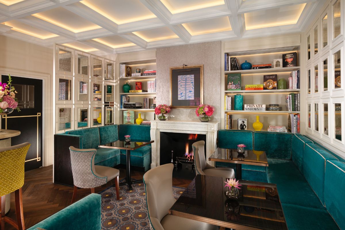 a room with a fireplace and tables