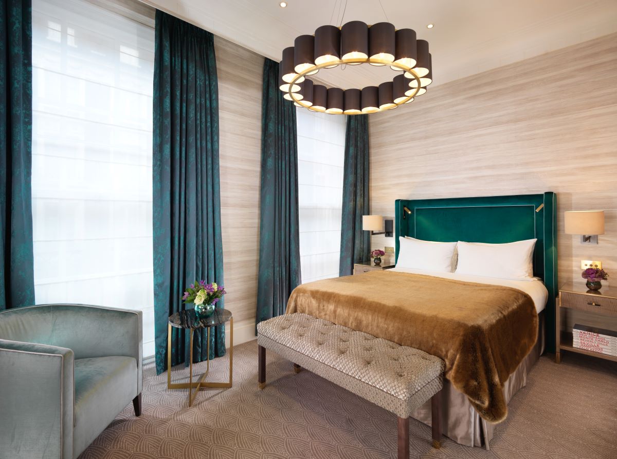 a bedroom with a bed and a chair