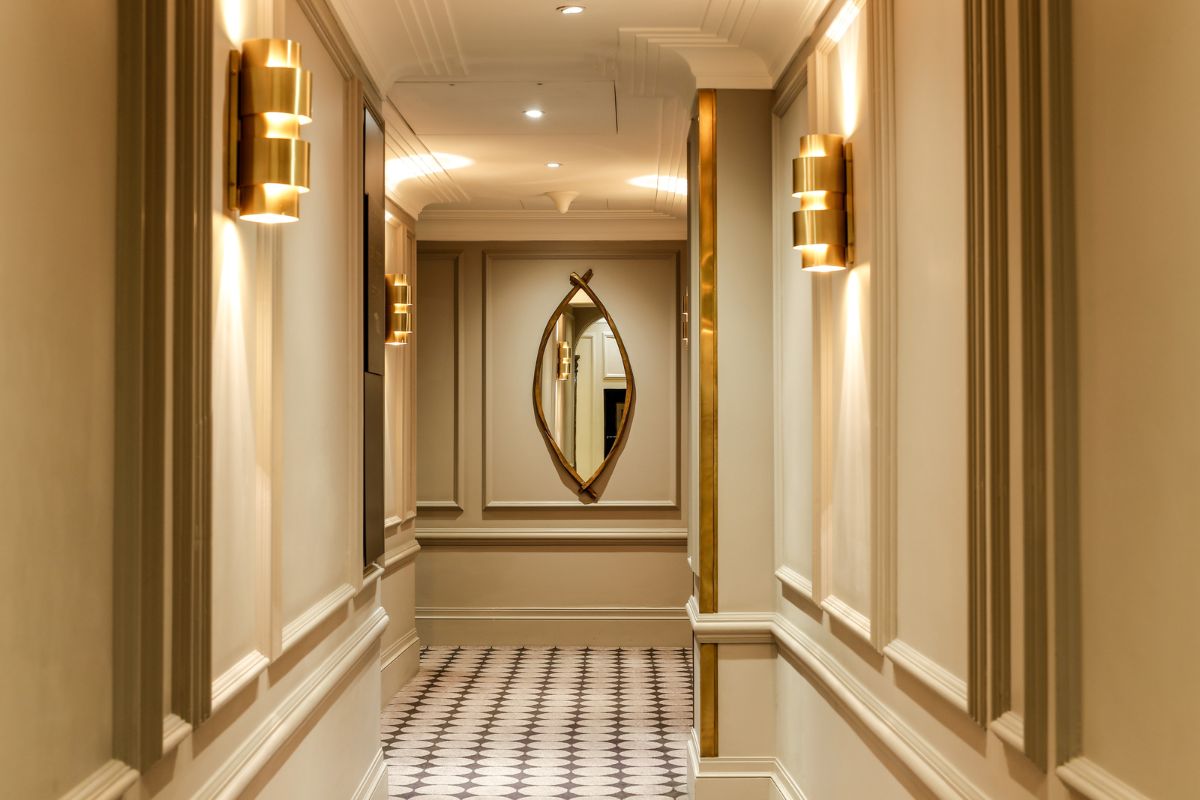 a hallway with a mirror on the wall