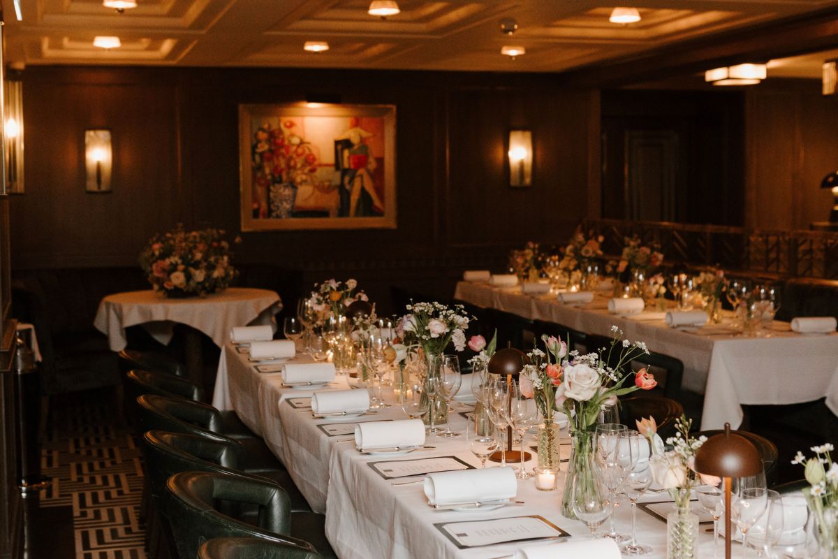 a long table with white tablecloths and flowers