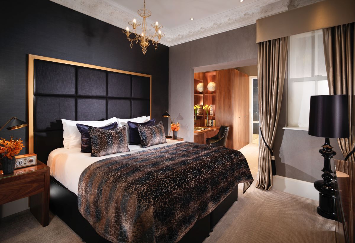 a bedroom with a bed and a chandelier