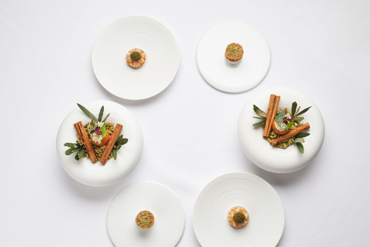 a group of white plates with food on them