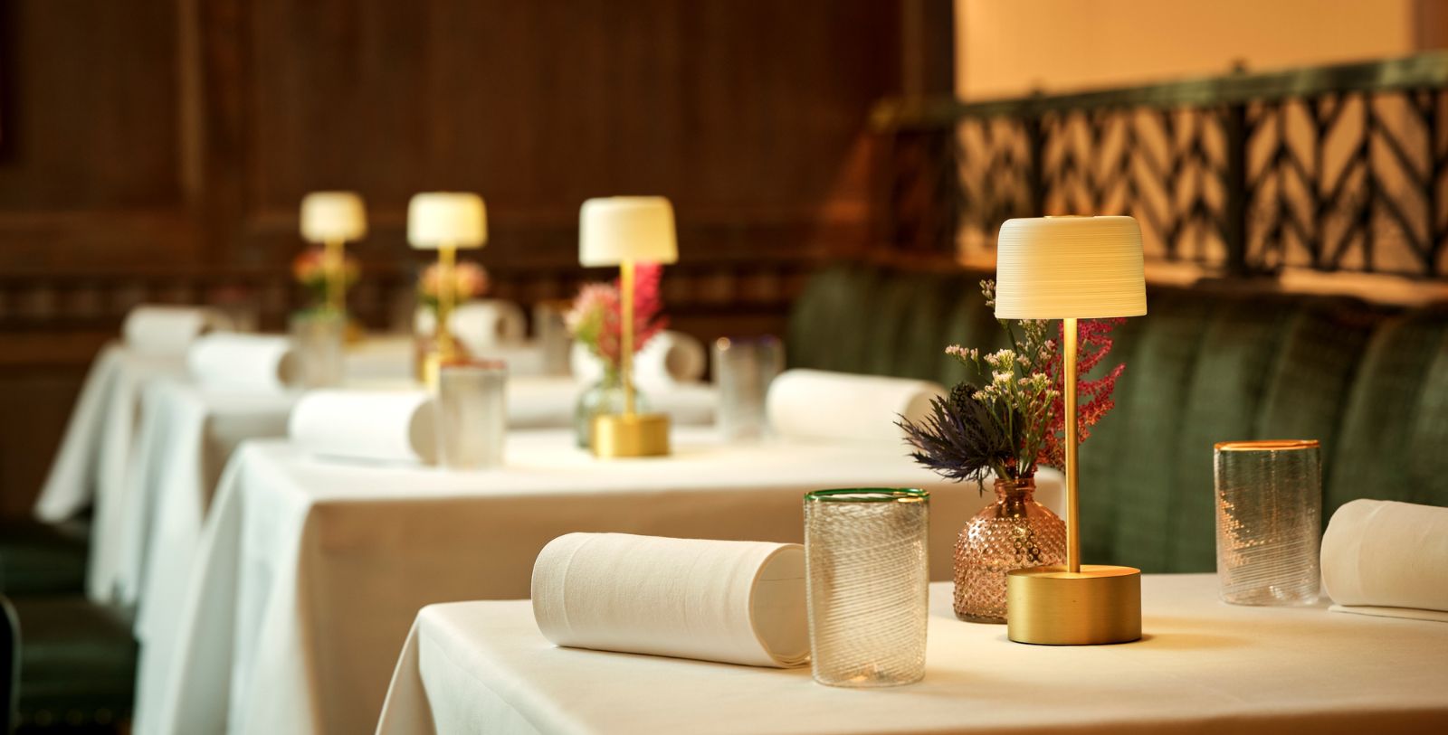 a table with white tablecloths and lamps