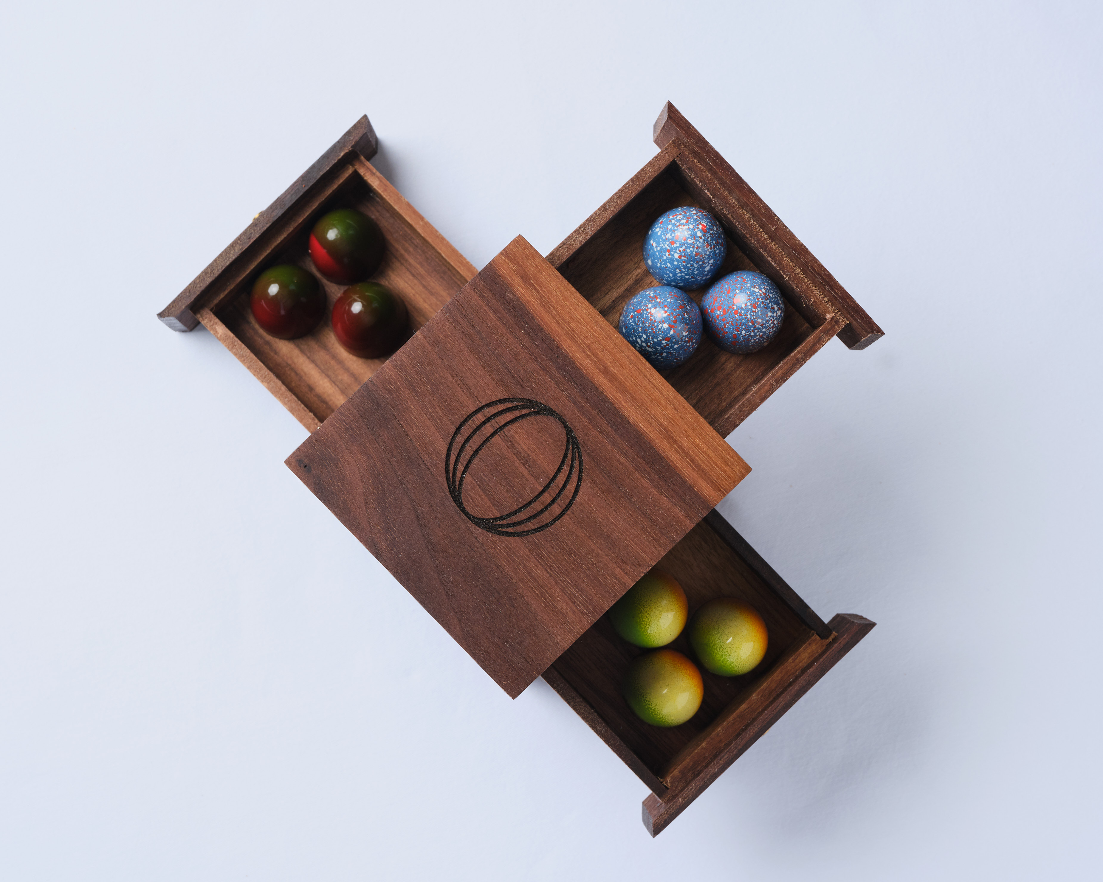 a wooden box with colorful balls inside