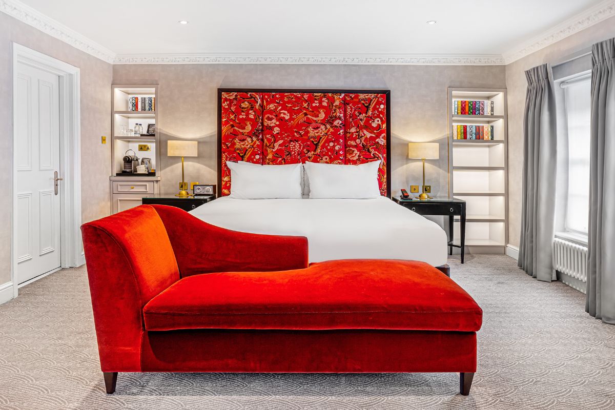 a room with a bed and a red couch