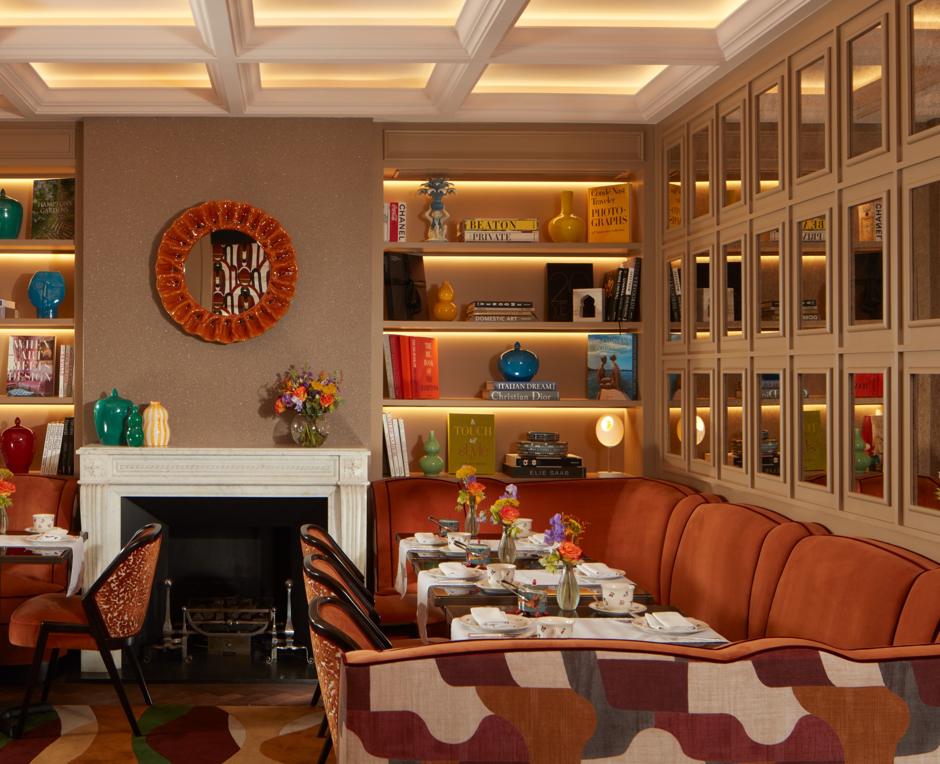 a room with a fireplace and a table set with flowers