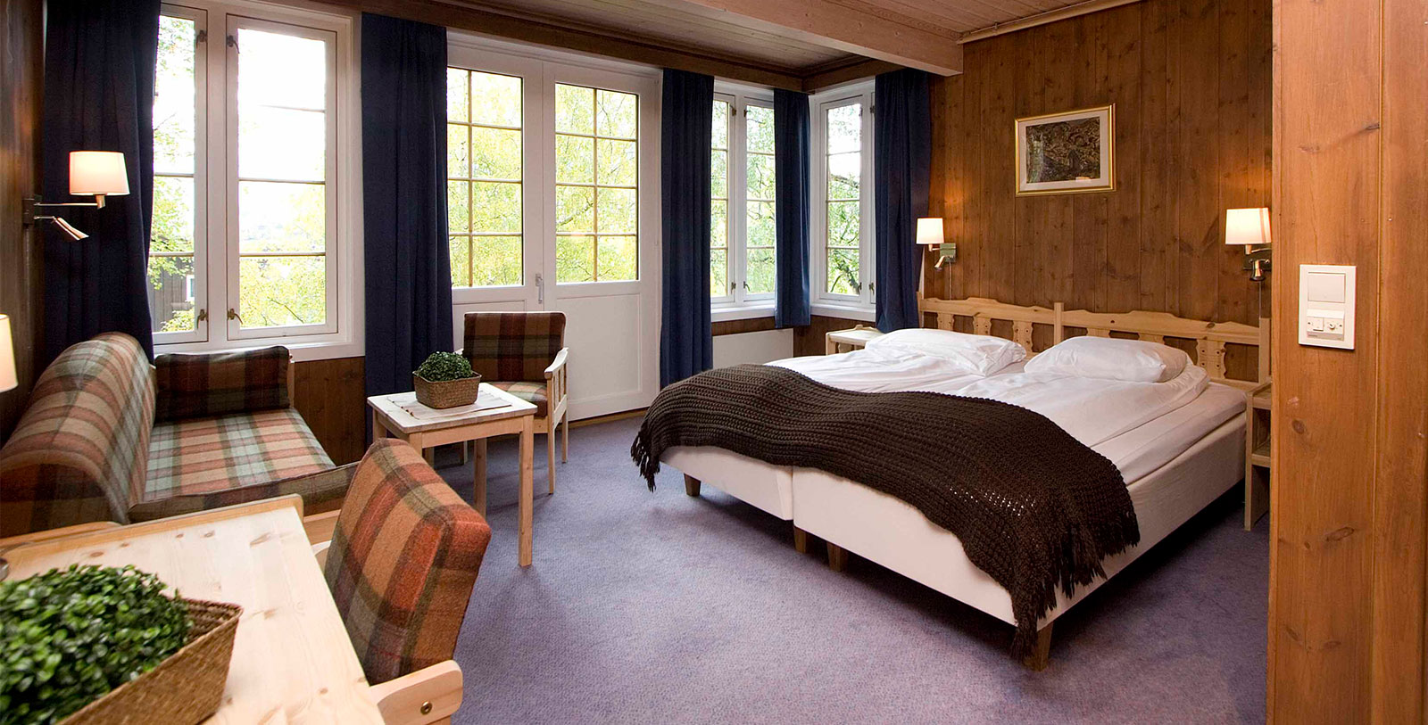 a bedroom with a bed and chairs