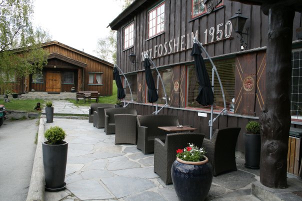 a patio area with chairs and umbrellas