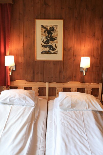 a bed with white sheets and pillows