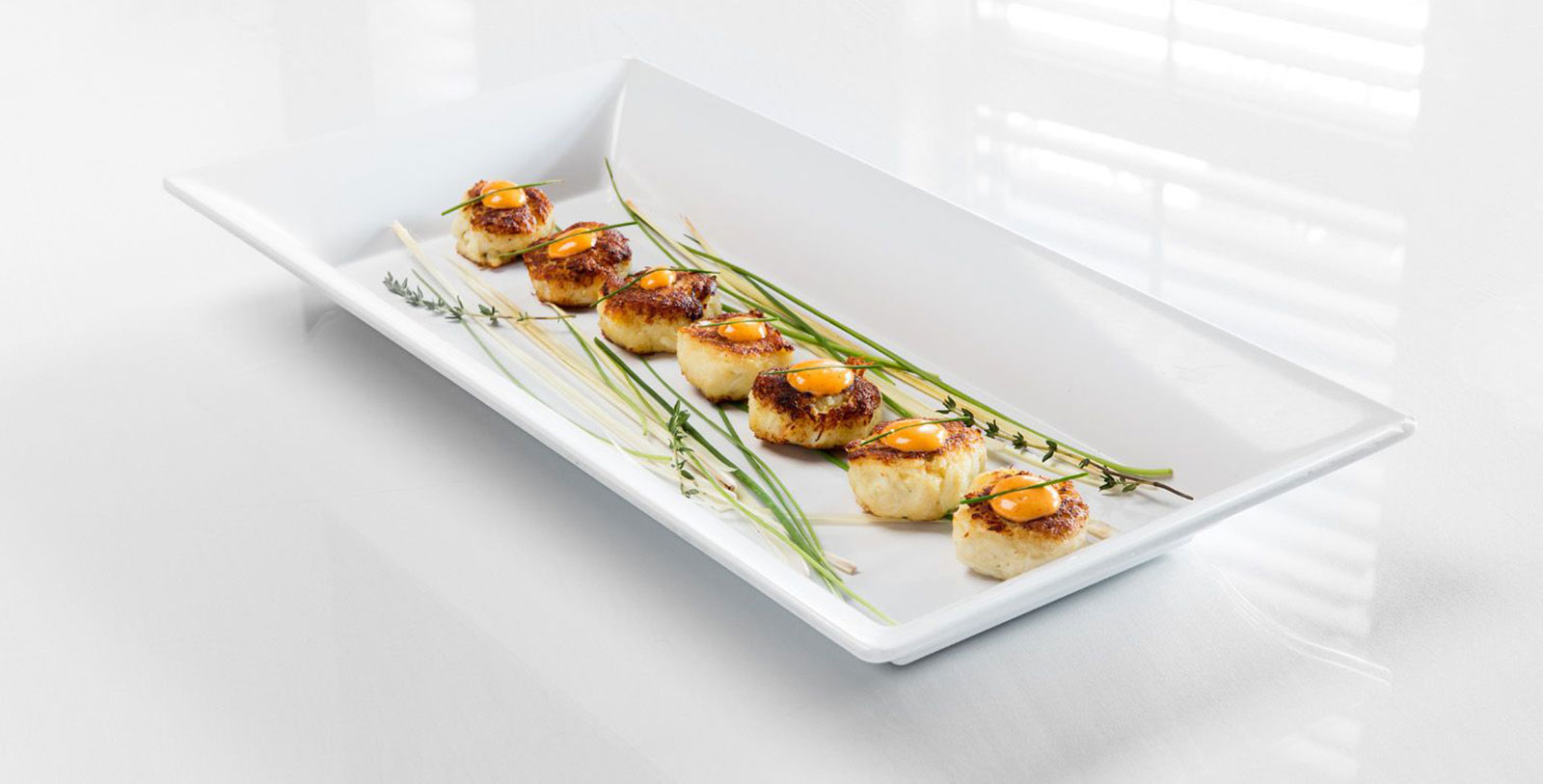 a plate of scallops with yellow yolk on top
