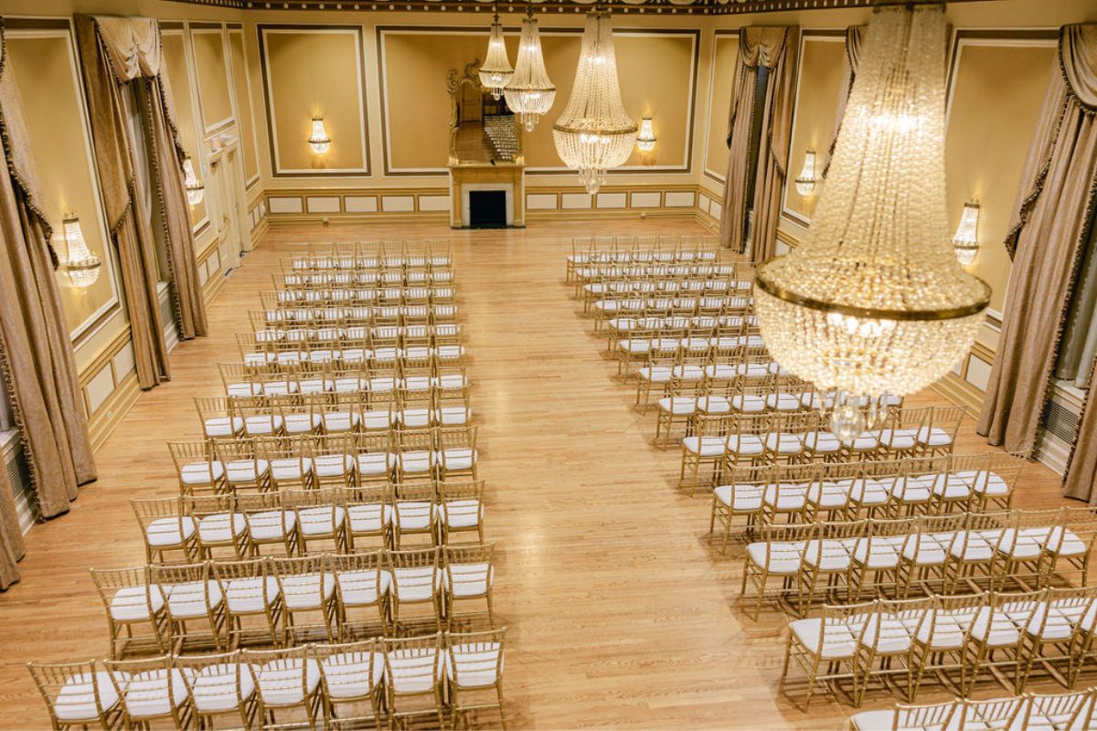 a room with chairs and chandeliers