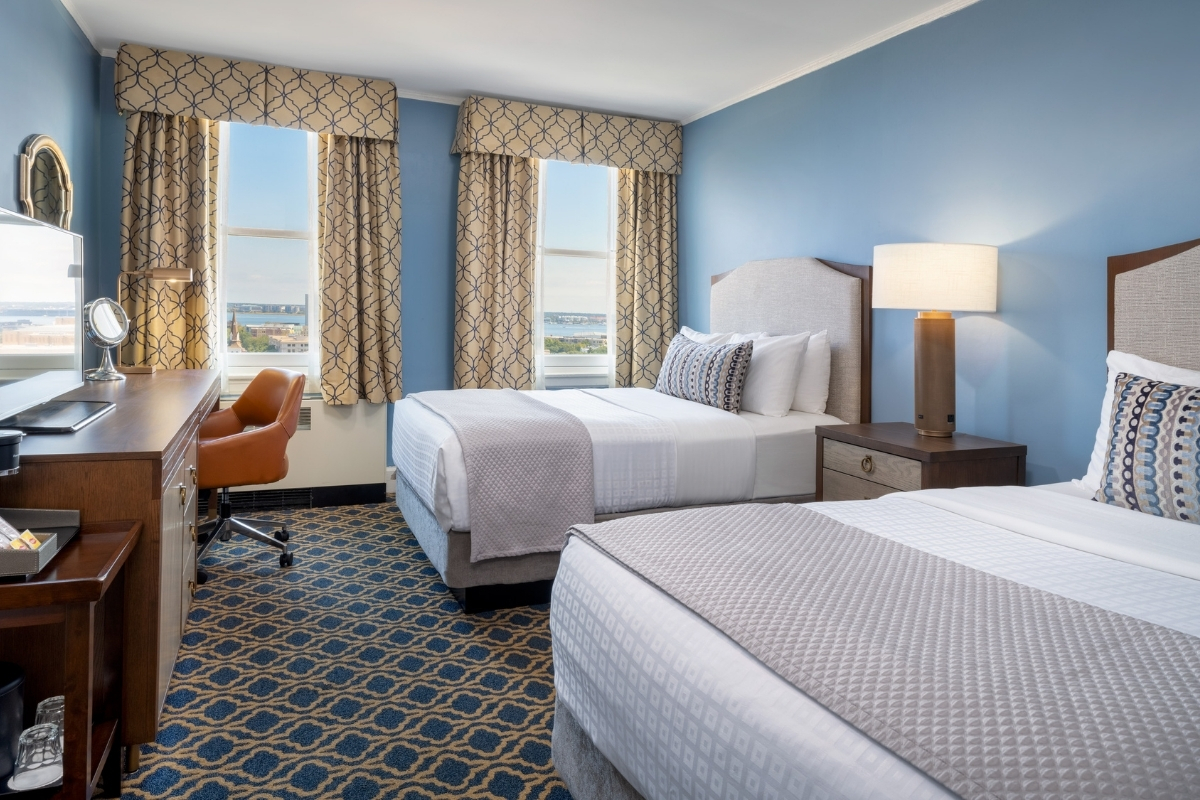 a room with two beds and a piano