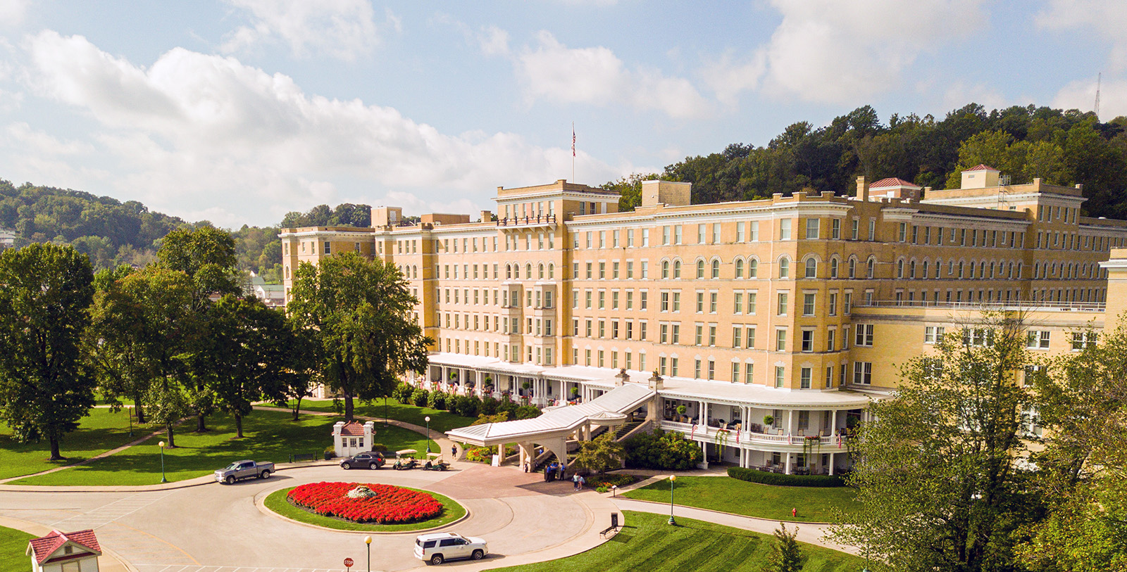 a large building with a lawn and flowers