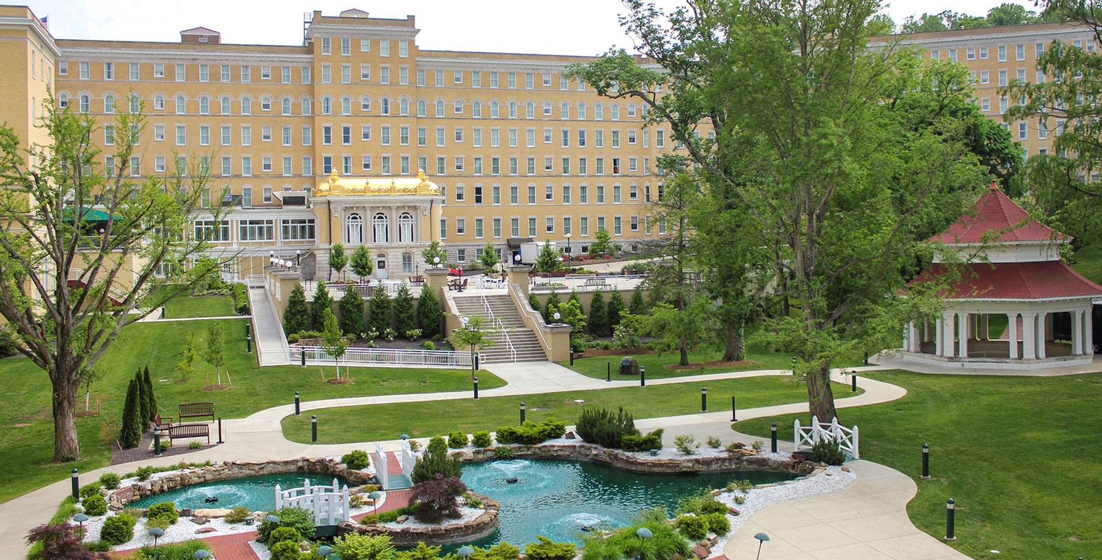 a building with a pond and trees