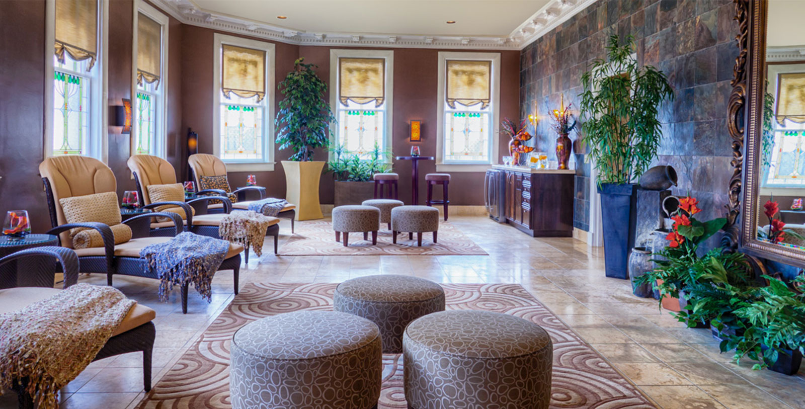 a room with a large round ottoman and chairs