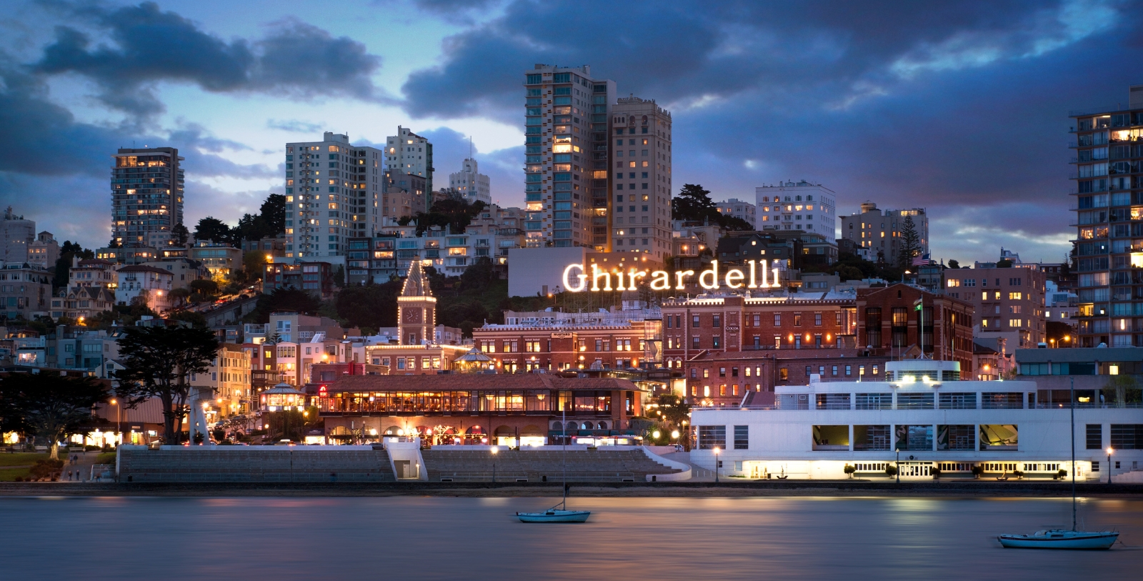 a city with lights on the side of the water 5