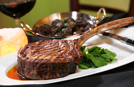 a steak on a plate with a bowl of food