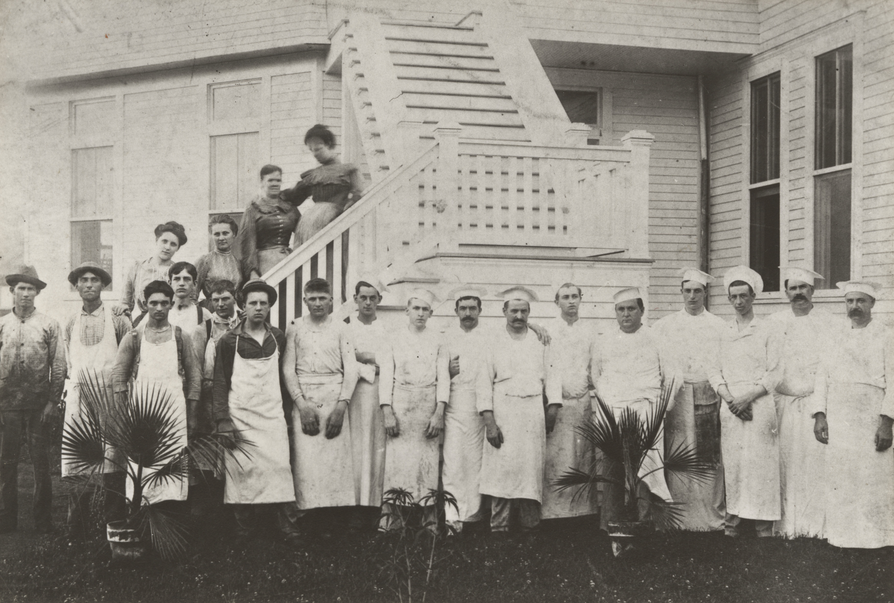 a group of people standing outside a house