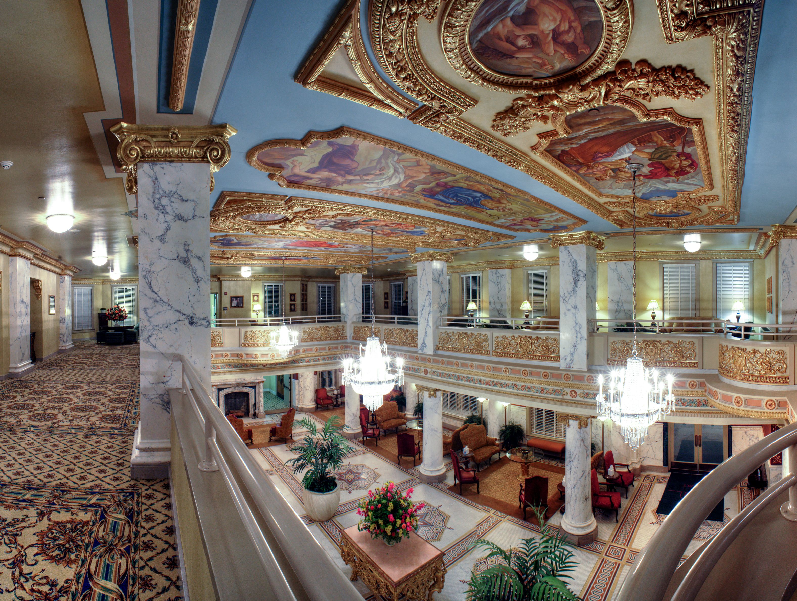 a large ornate building with ornate ceiling and chandeliers