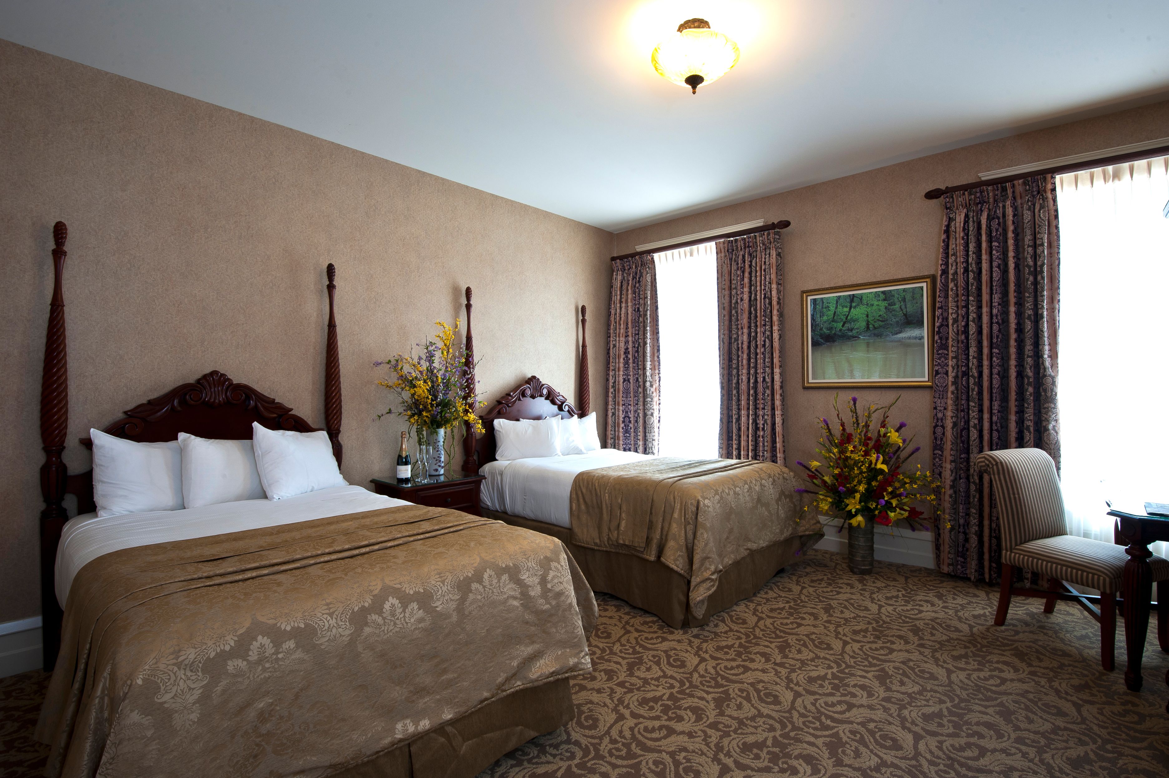 a room with two beds and flowers