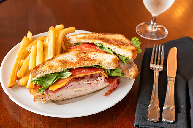 a plate of sandwich and fries