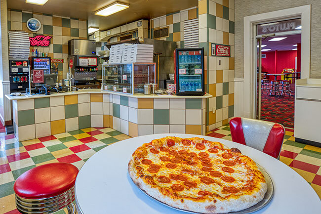 a pizza on a table in a restaurant