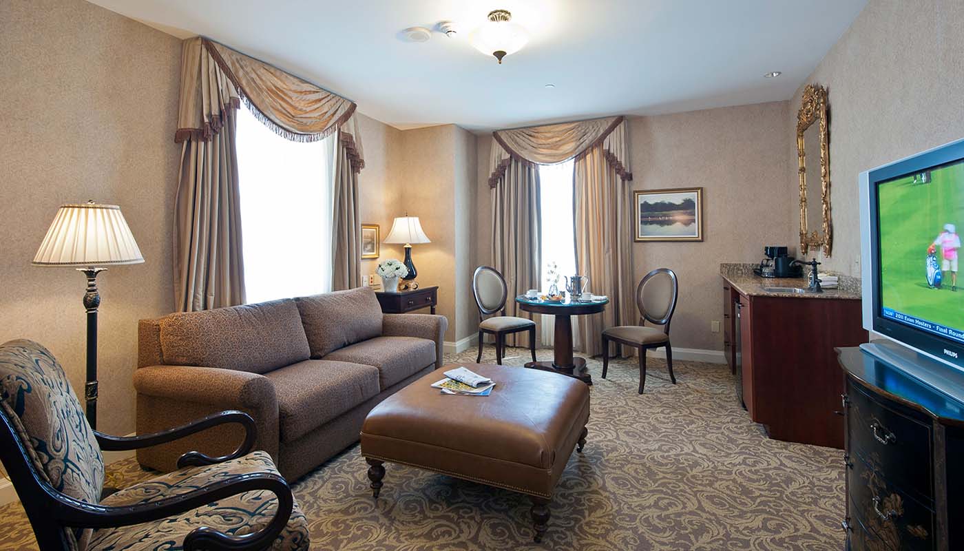a living room with a couch and chairs