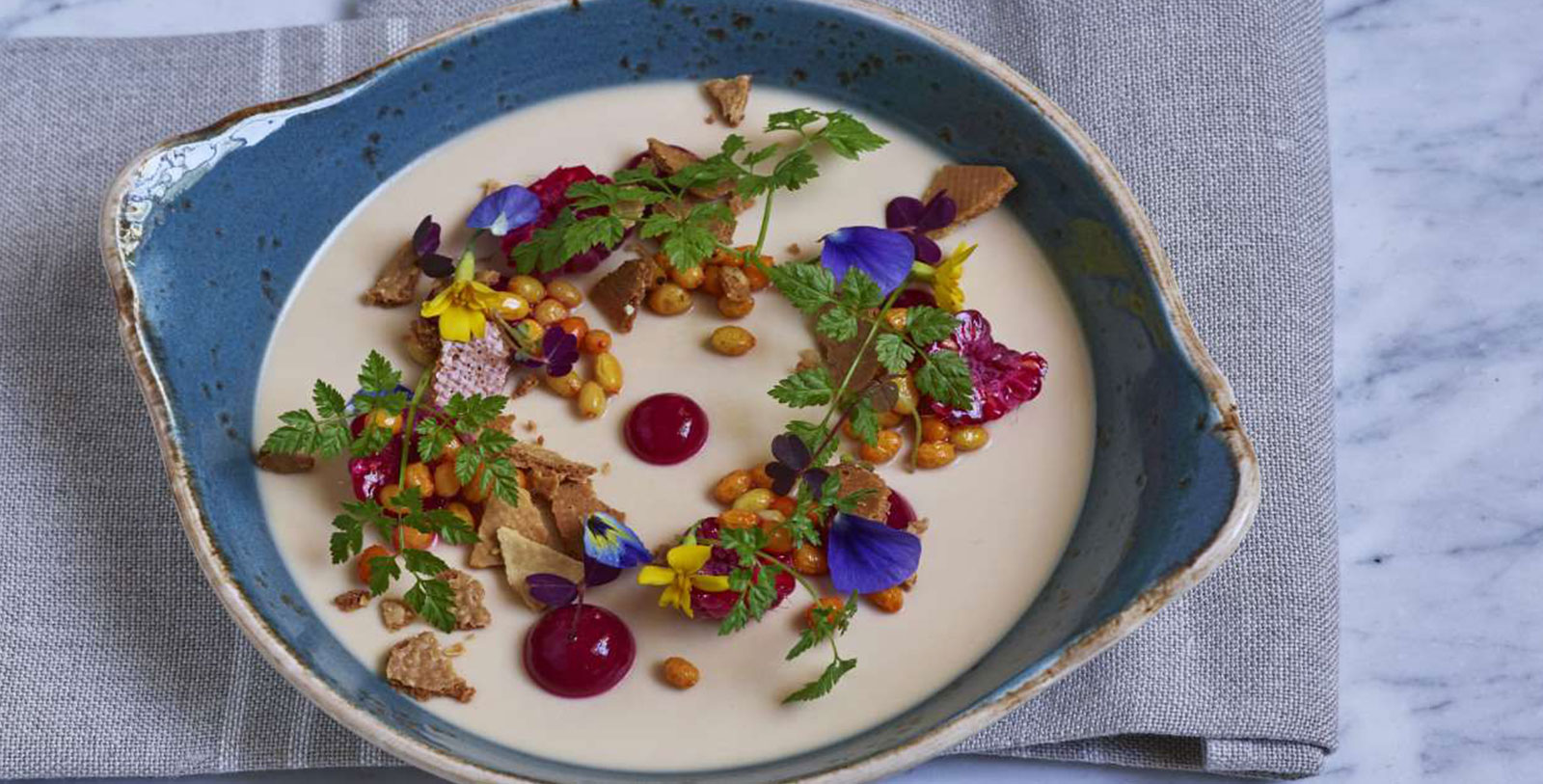 a bowl of food with flowers and leaves