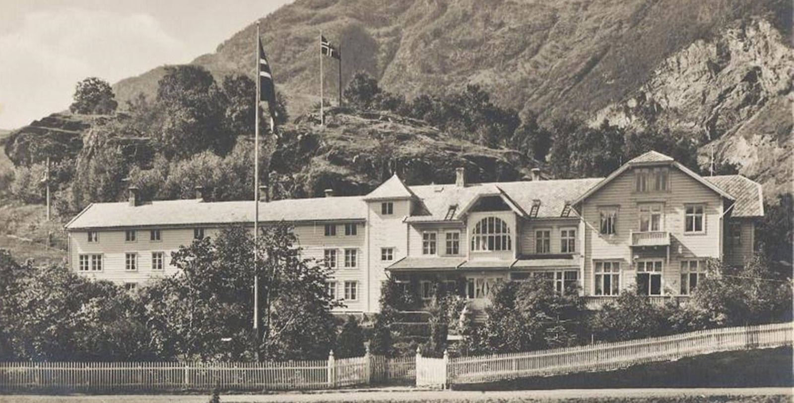 a large white house with a flag on the side