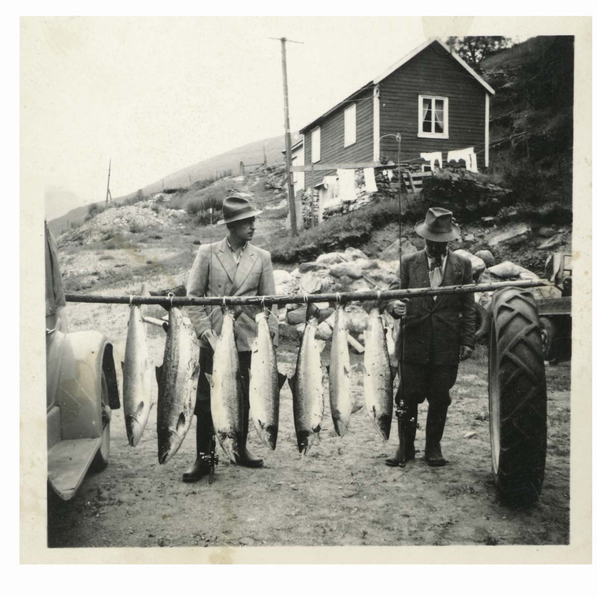 a group of men holding fish