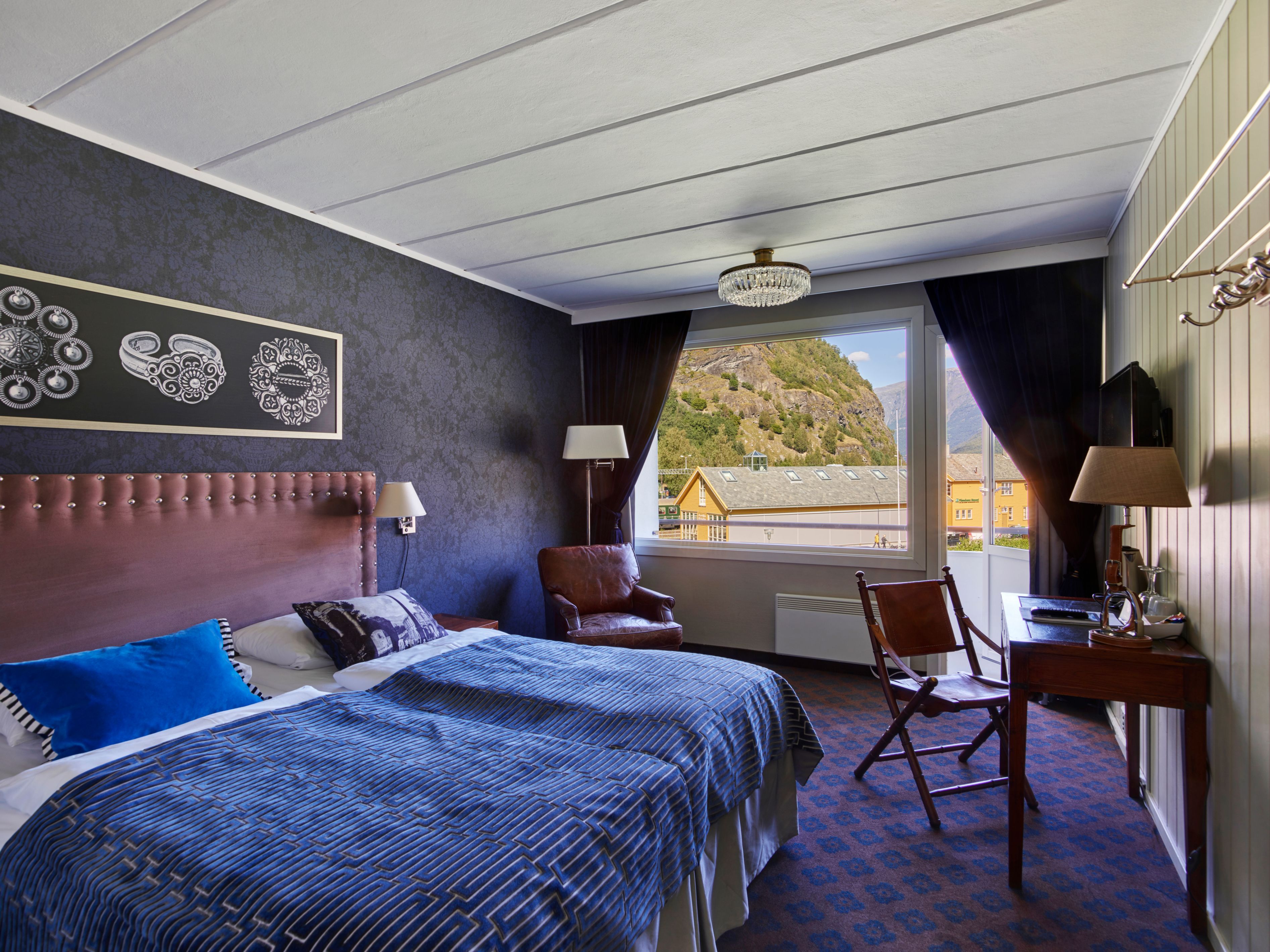 a room with a bed and a desk and chair