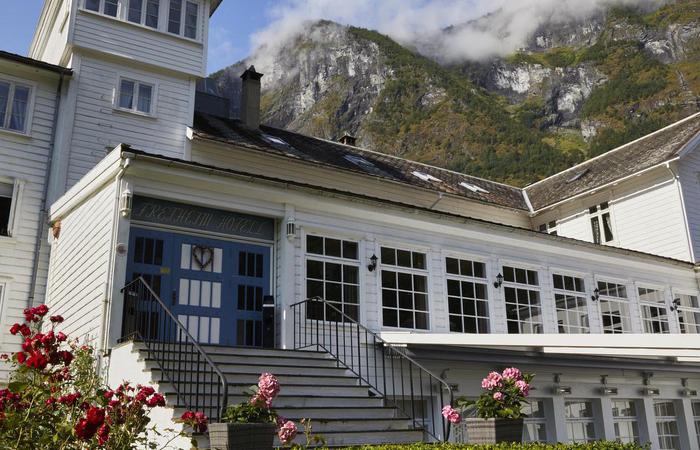 a white building with stairs and flowers