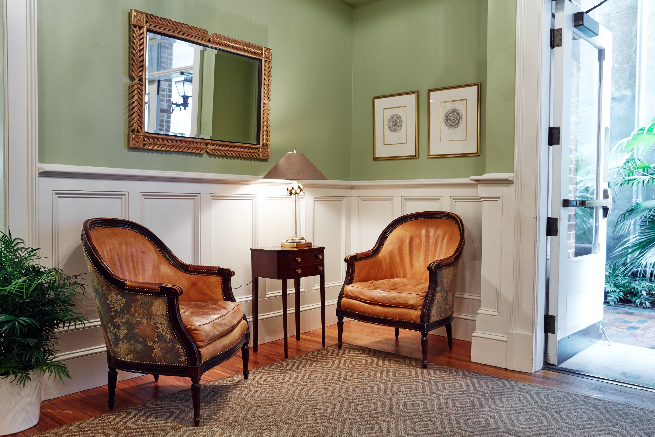 a room with a mirror and chairs