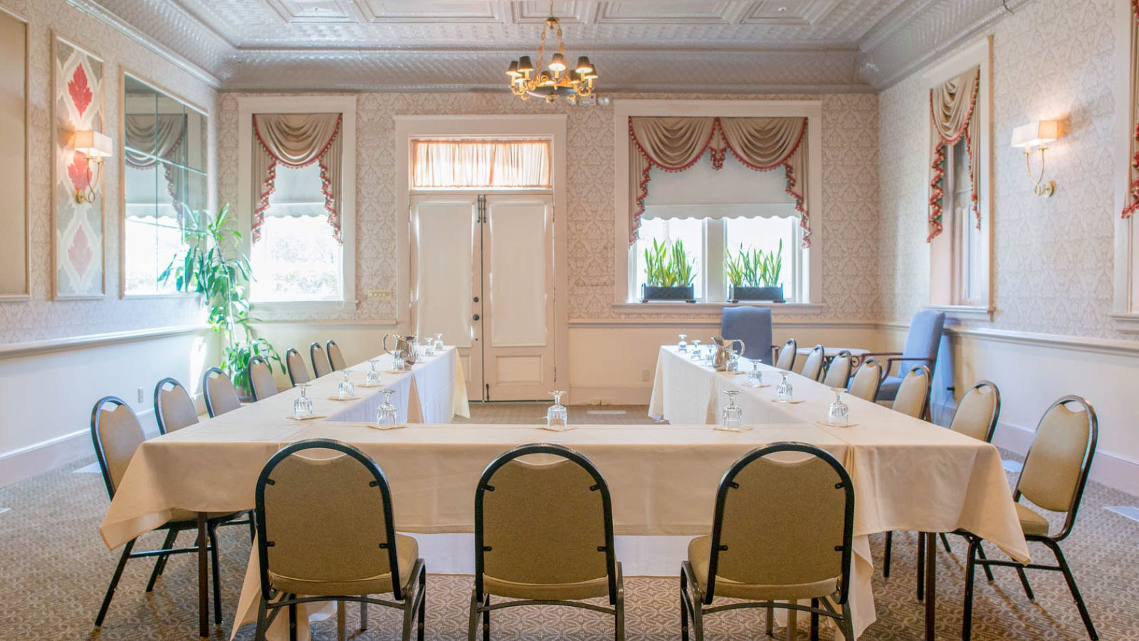 a room with long tables and chairs