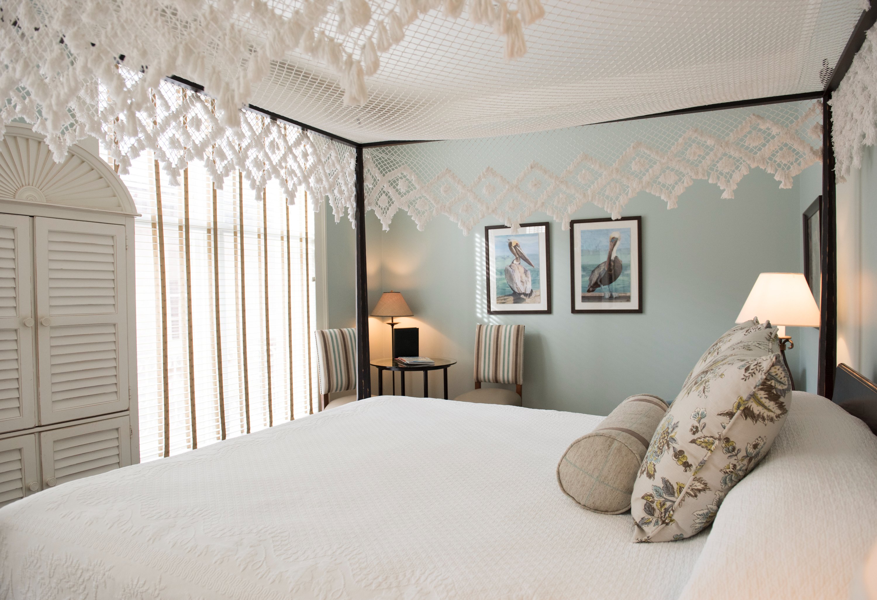 a bed with pillows and a lamp