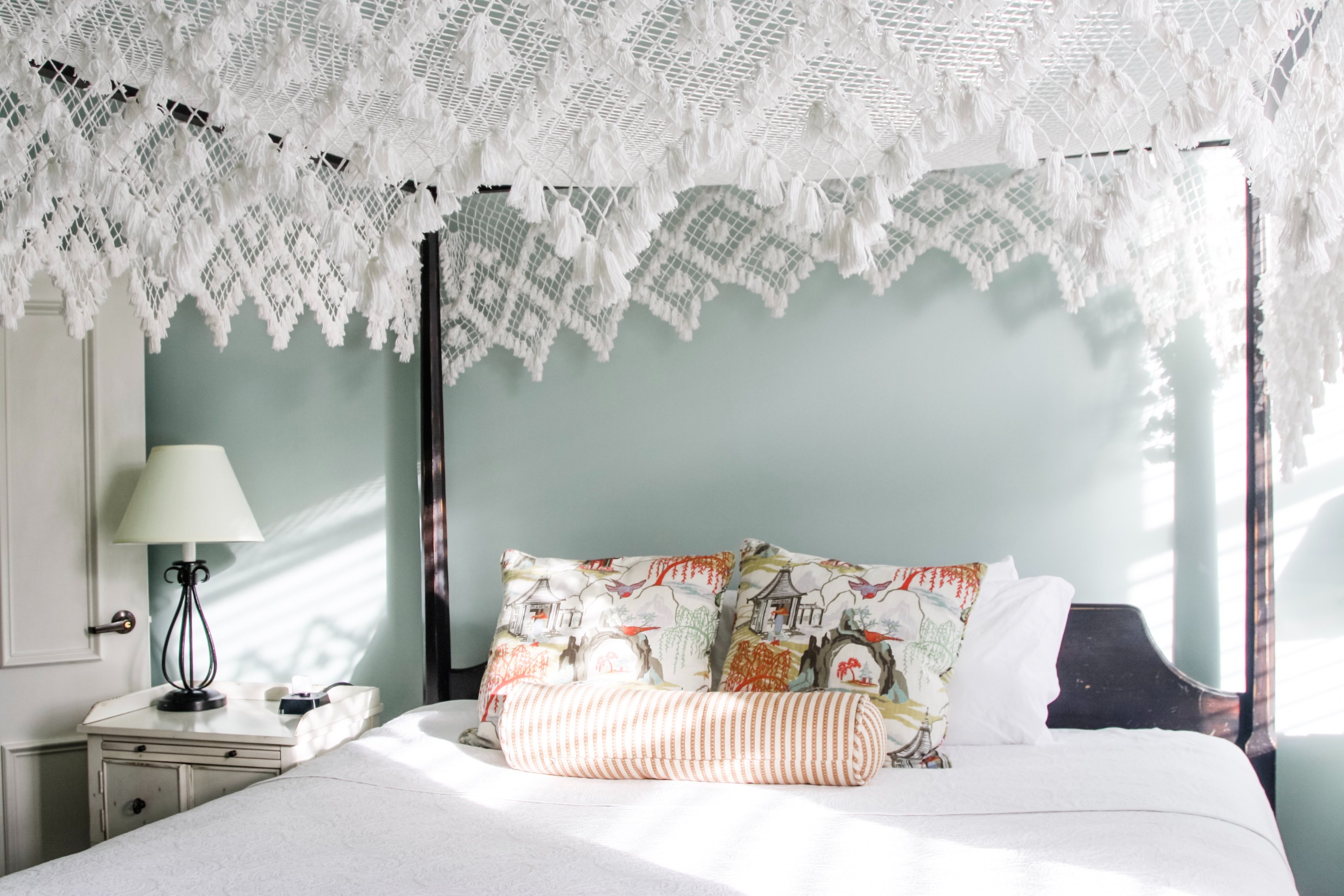 a bed with a white canopy over it