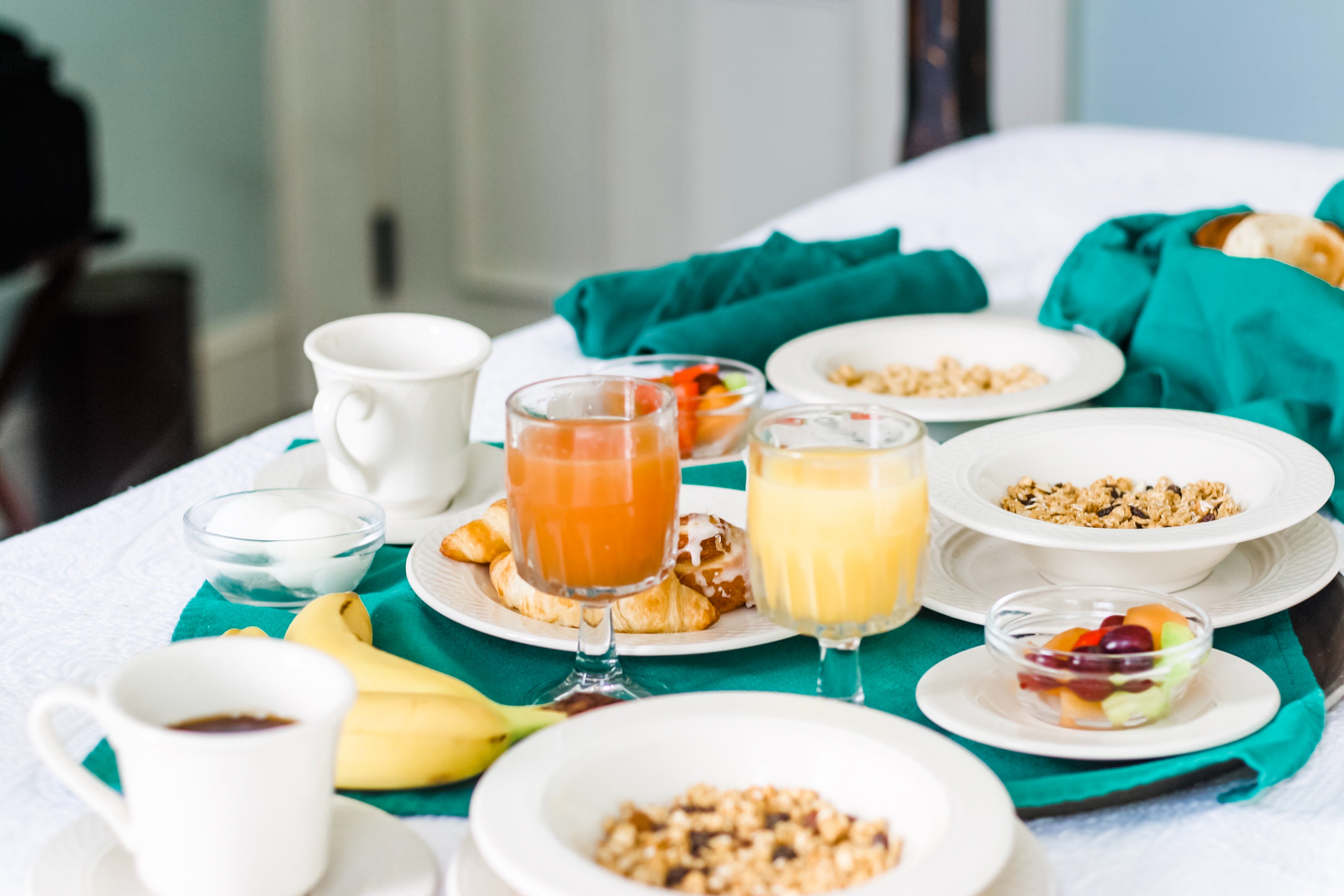 a table with plates of food and drinks
