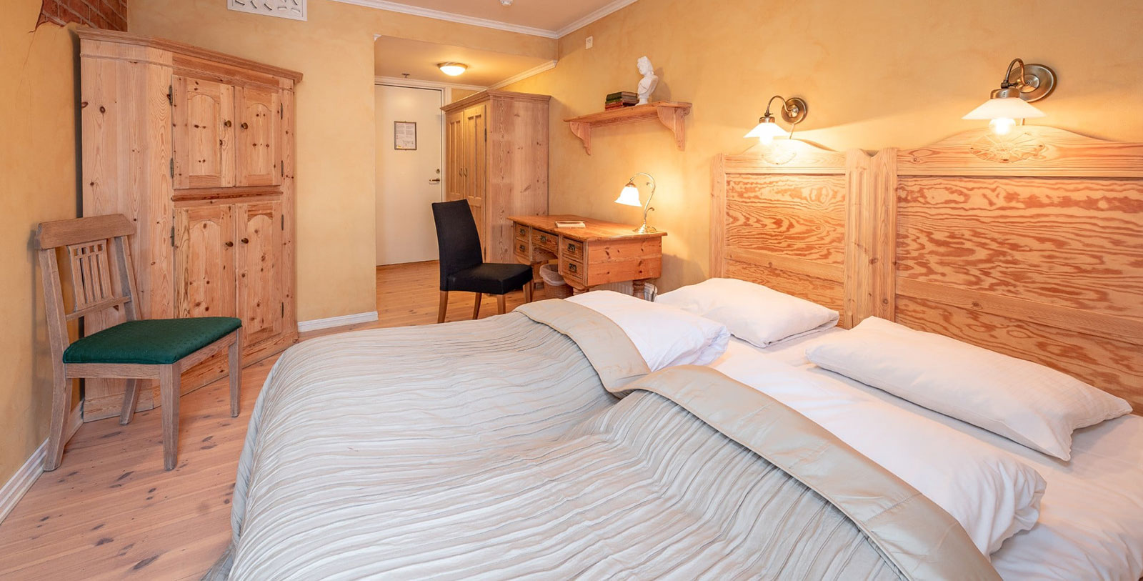 a room with two beds and a desk
