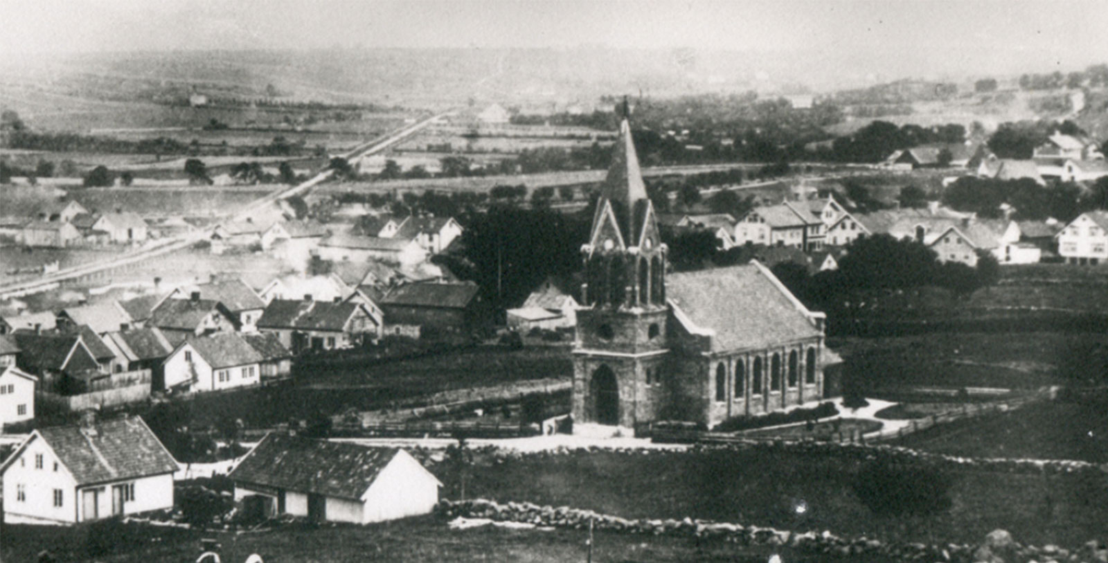 a church with a steeple and a small town