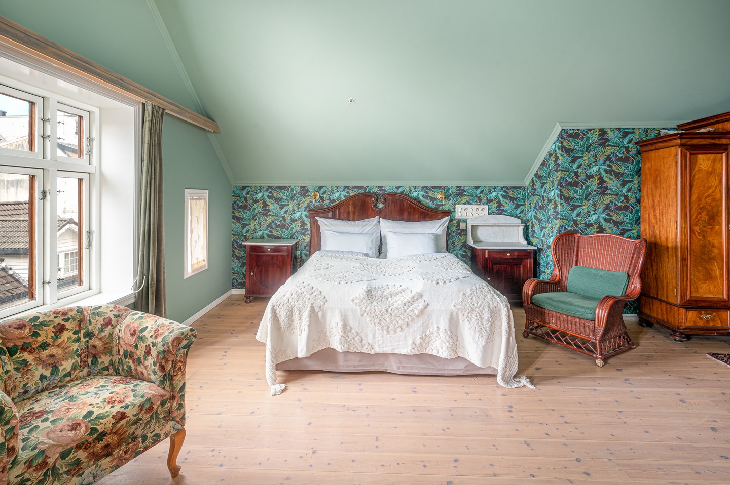 a bedroom with a bed and chairs