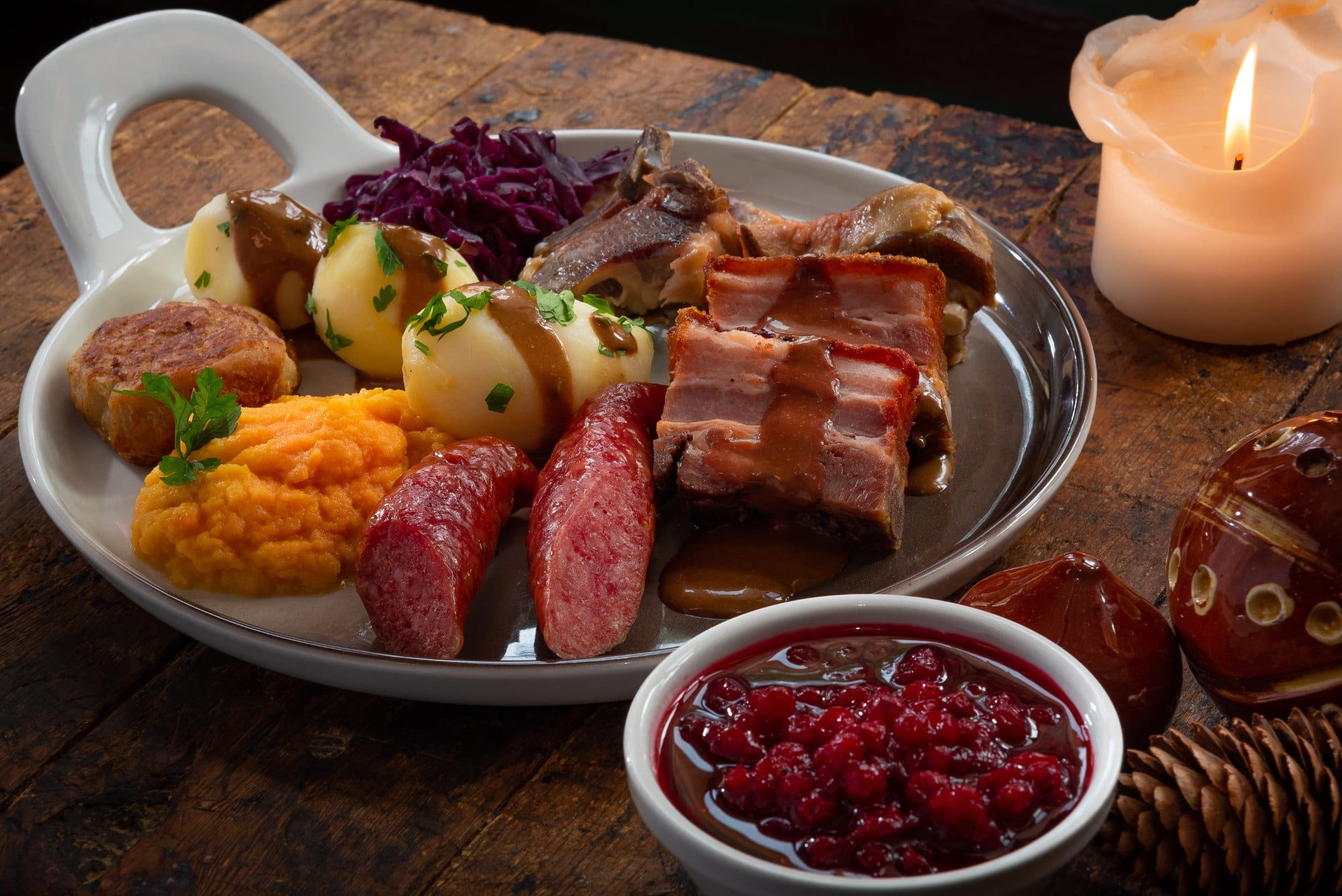 a plate of food with a candle and a candle
