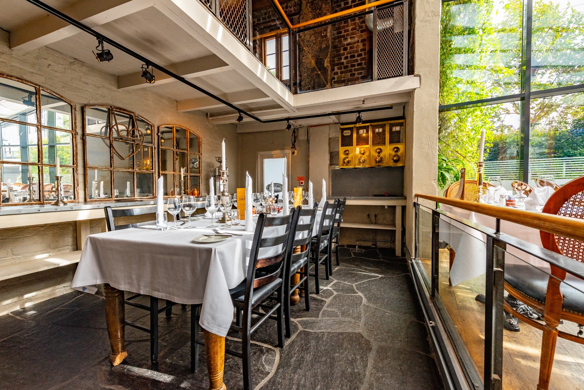 a dining table with candles and chairs