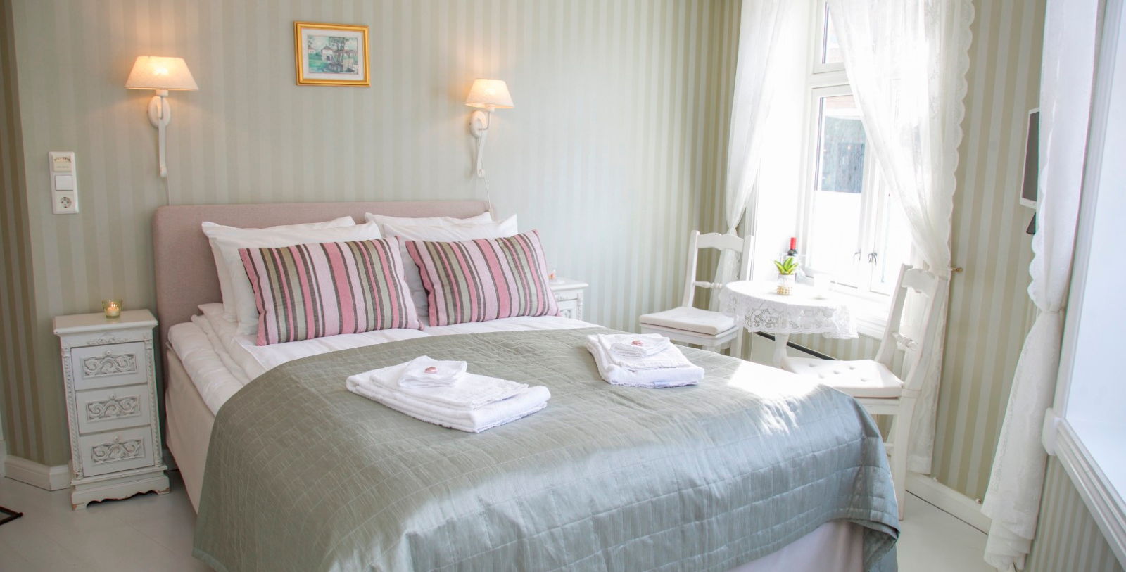 a bed with pink and white towels on it