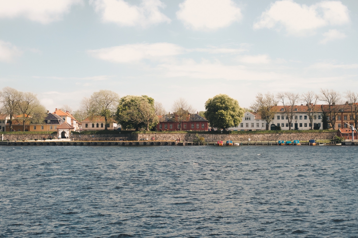 a body of water with houses and trees