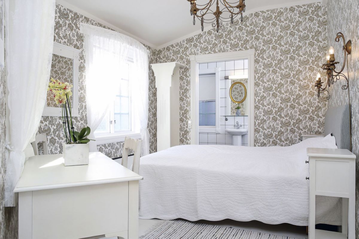 a bedroom with a bed and a sink