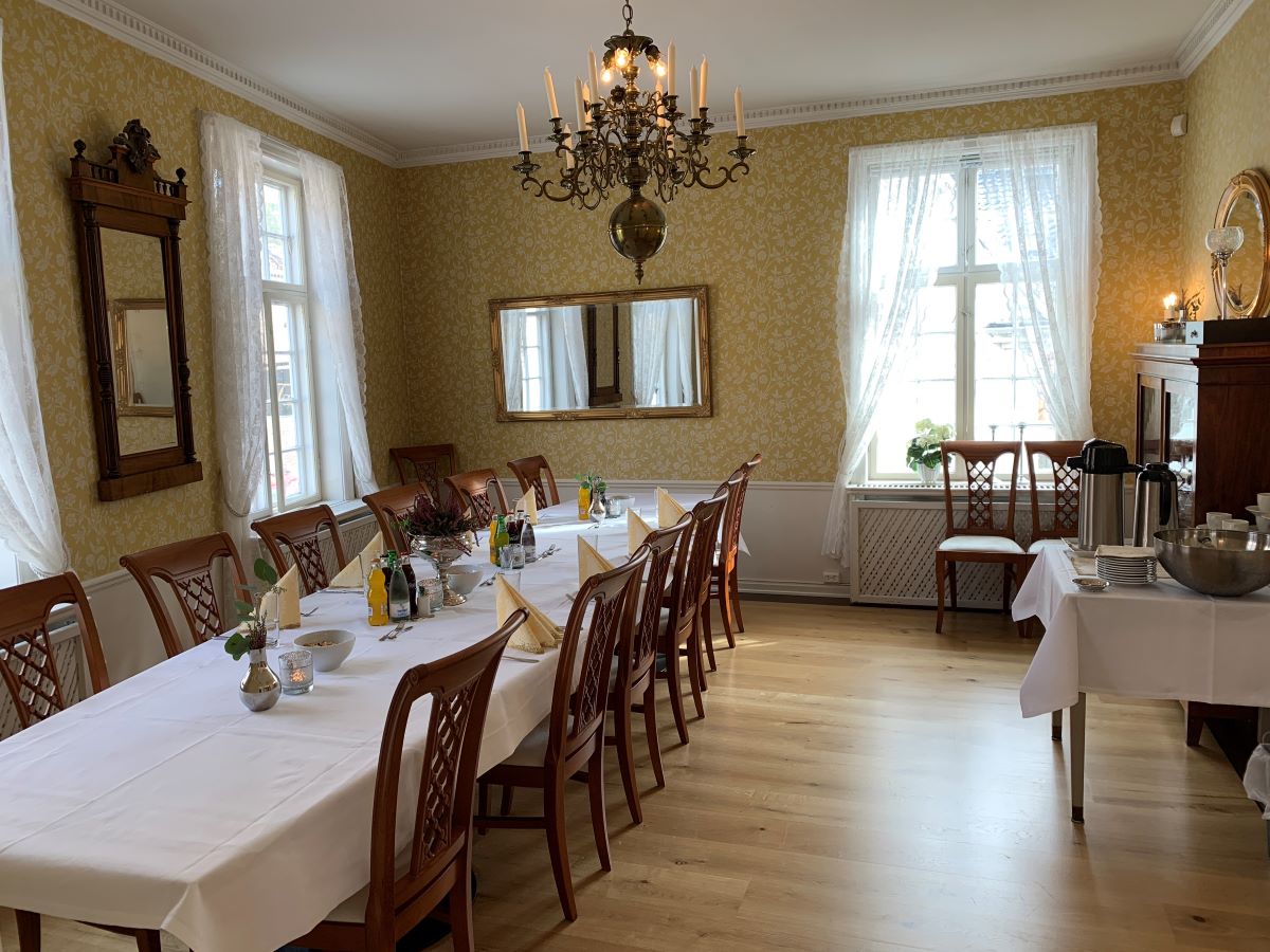 a dining room with a chandelier and table set up