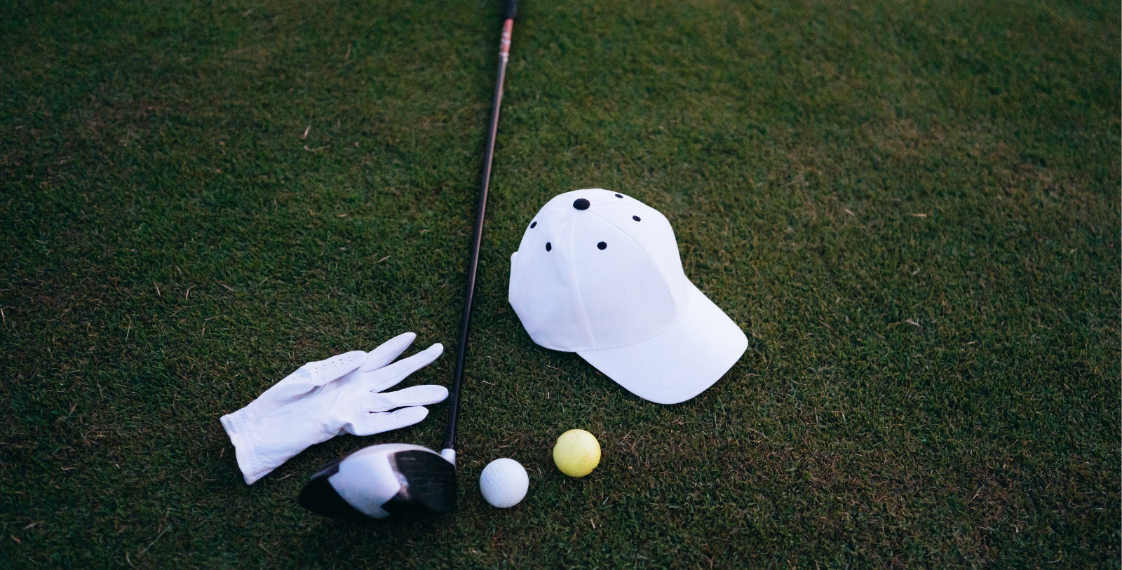 a golf club and ball on grass