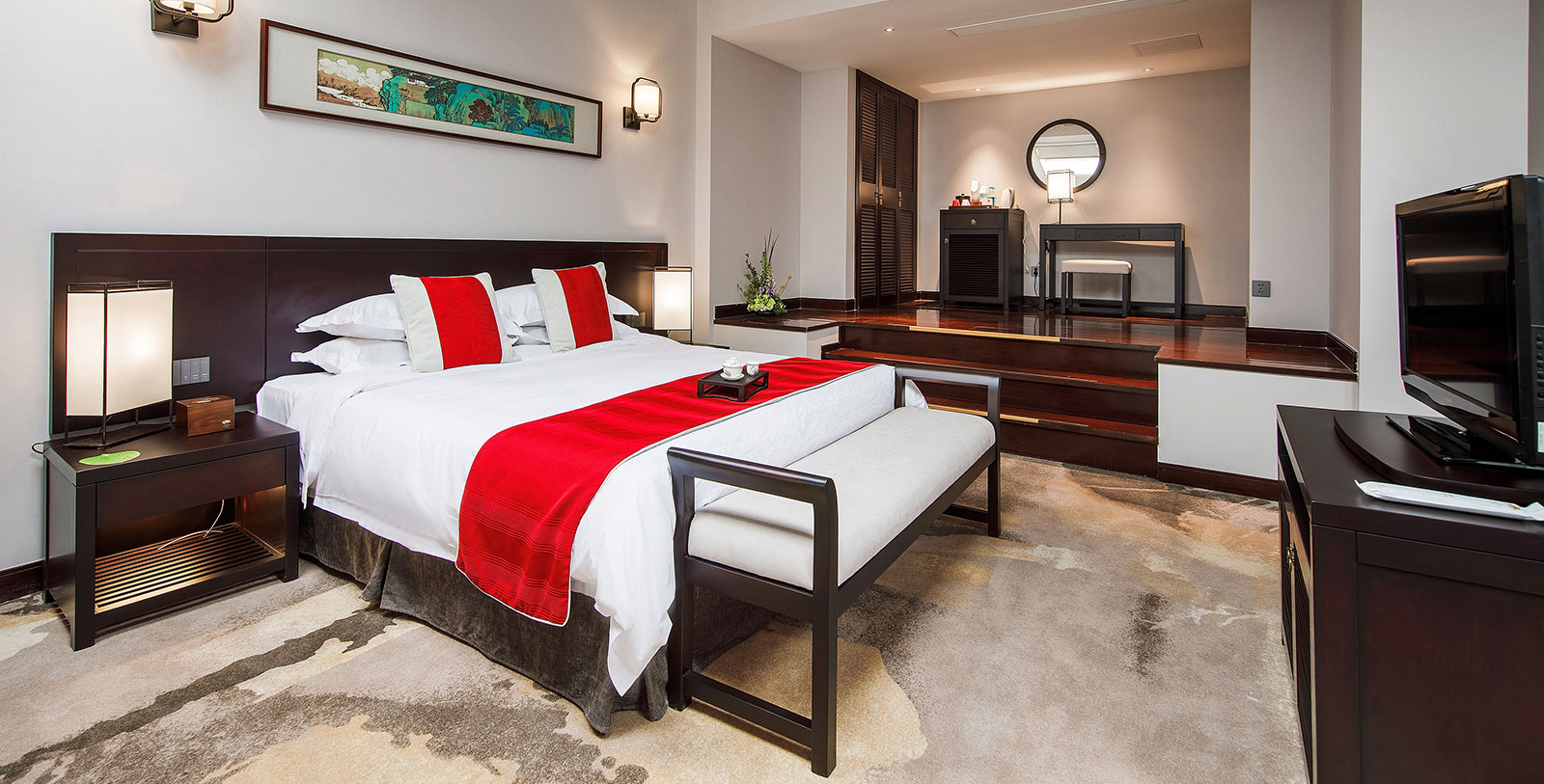 a bedroom with a bed and a mirror