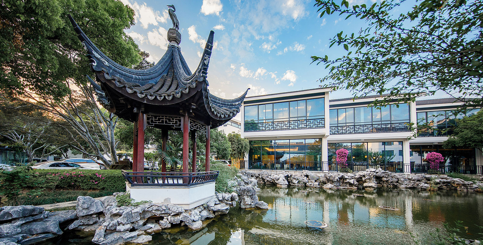 a building with a pond and a gazebo