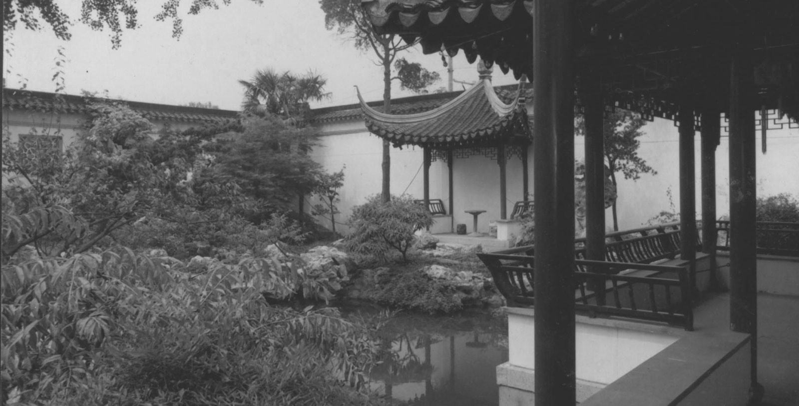 a building with a pond and trees